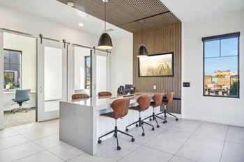A conference room with a long desk and chairs